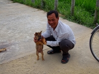 Bicycle tour guide playing with a local dog